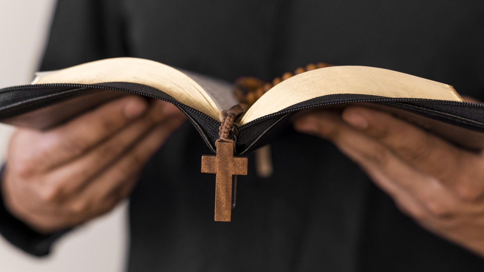 front-view-person-with-holy-book-rosary